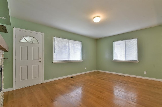 foyer with a healthy amount of sunlight and light hardwood / wood-style flooring