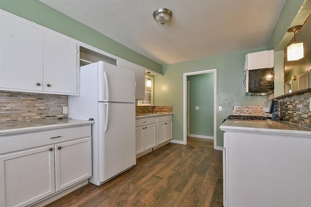 kitchen featuring white refrigerator, white cabinetry, dark wood-type flooring, and range