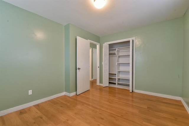 unfurnished bedroom with a closet and light wood-type flooring