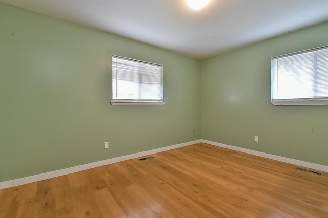 unfurnished room with light hardwood / wood-style floors