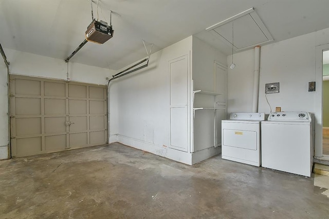 garage with separate washer and dryer and a garage door opener