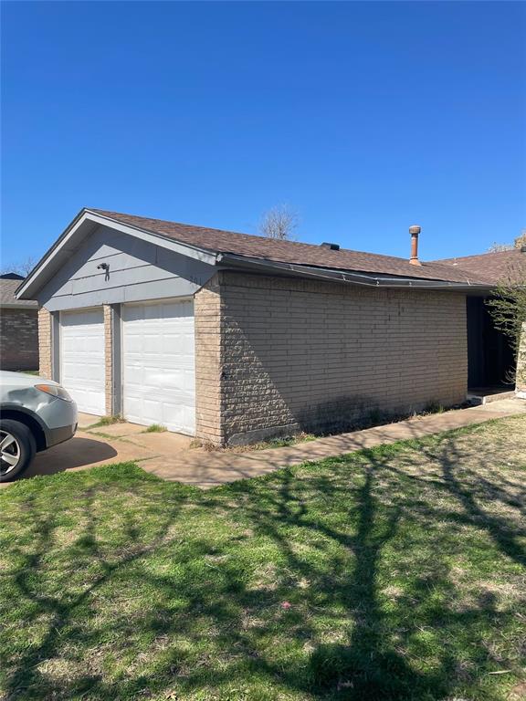 garage featuring a yard