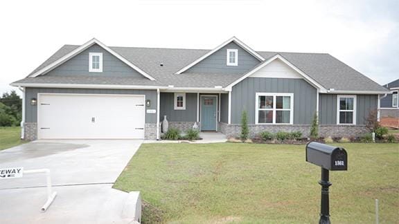 craftsman-style home featuring a garage and a front lawn