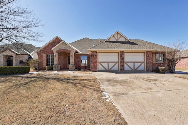 view of front of property featuring a garage and a front lawn