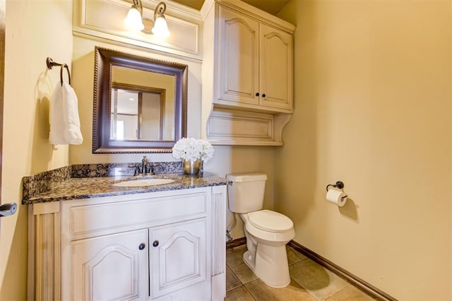 bathroom with vanity, tile patterned floors, and toilet