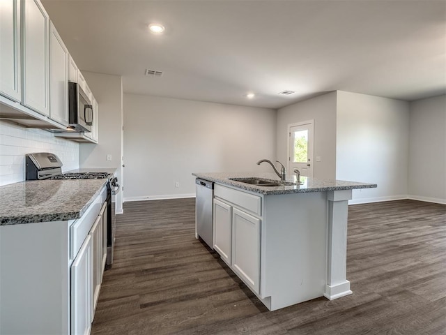 13136 Mannington Rd, Edmond, OK 73025 - kitchen with a sink, appliances with stainless steel finishes, dark wood-type flooring, baseboards, and tasteful backsplash