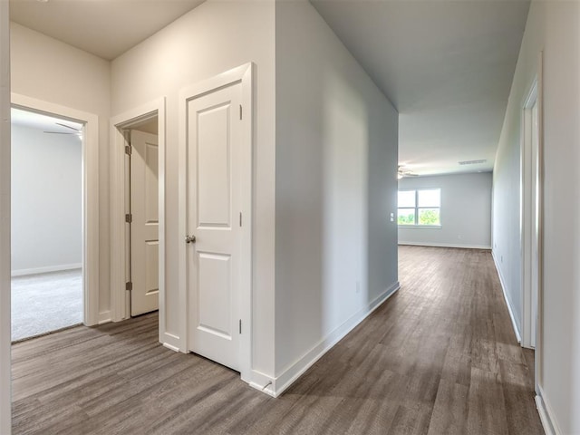 13136 Mannington Rd, Edmond, OK 73025 - hallway with dark wood-type flooring and baseboards