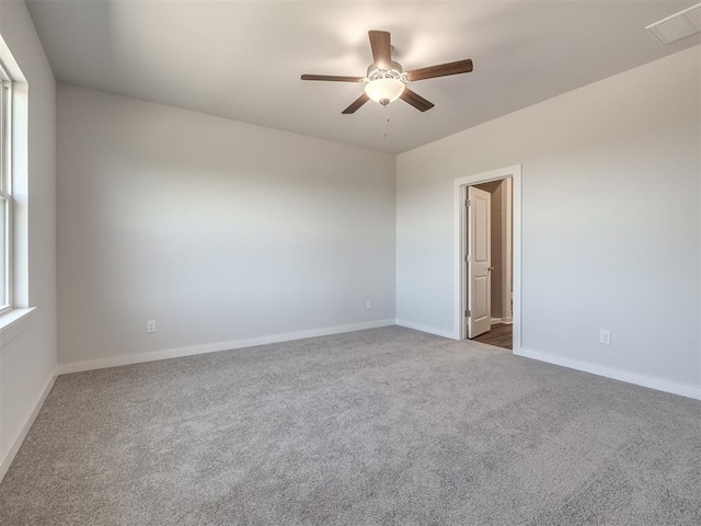 13136 Mannington Rd, Edmond, OK 73025 - empty room with a ceiling fan, dark colored carpet, and baseboards