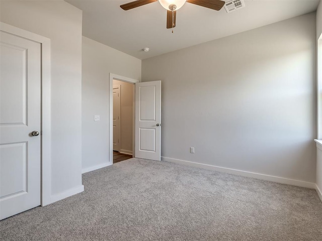 13136 Mannington Rd, Edmond, OK 73025 - unfurnished bedroom with carpet flooring, baseboards, and a ceiling fan