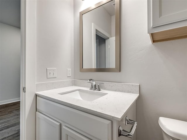 13136 Mannington Rd, Edmond, OK 73025 - half bath with vanity, toilet, and wood finished floors