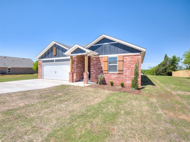13136 Mannington Rd, Edmond, OK 73025 - view of front of property featuring driveway, an attached garage, a front lawn, brick siding, and board and batten siding