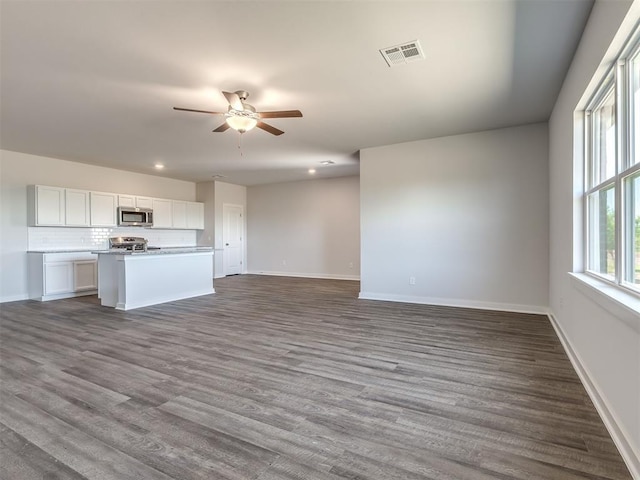 13136 Mannington Rd, Edmond, OK 73025 - unfurnished living room with recessed lighting, a ceiling fan, baseboards, and dark wood-style flooring