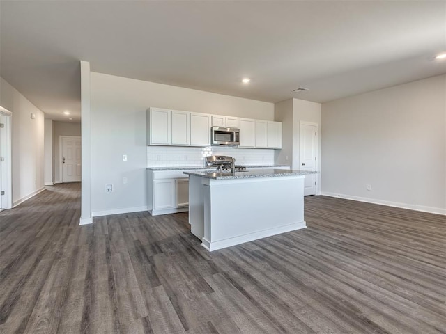 13136 Mannington Rd, Edmond, OK 73025 - kitchen featuring stainless steel microwave, dark wood-style flooring, range, baseboards, and recessed lighting