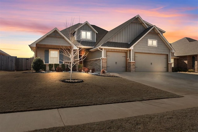 craftsman house featuring fence, roof with shingles, an attached garage, concrete driveway, and brick siding