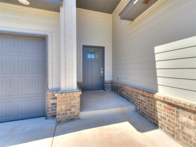 doorway to property with a garage