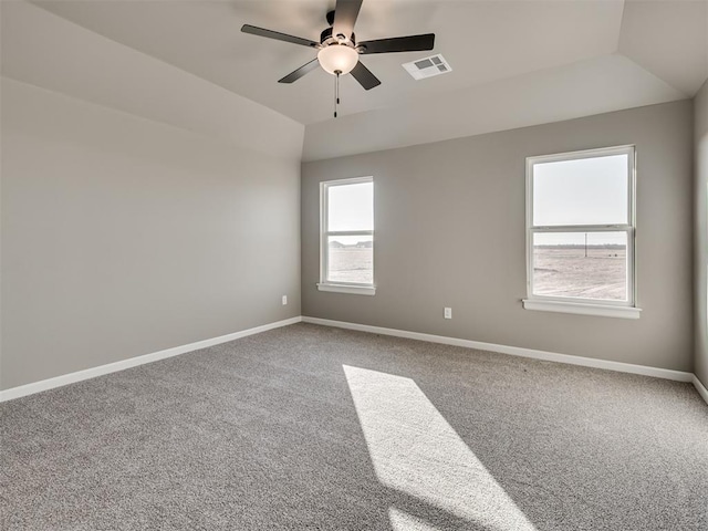 empty room featuring lofted ceiling, ceiling fan, and carpet