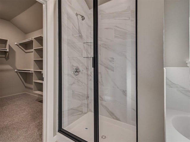 bathroom featuring an enclosed shower and vaulted ceiling