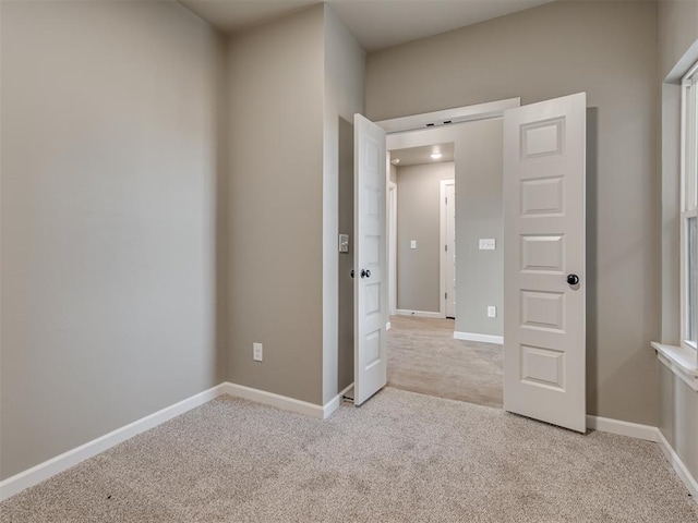 unfurnished bedroom featuring light colored carpet