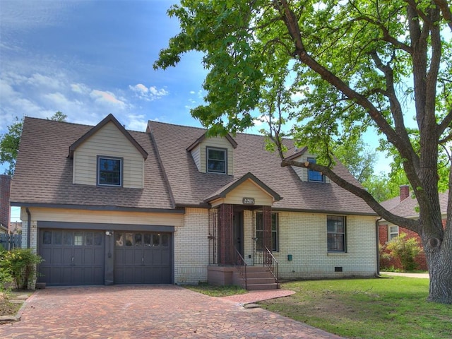 cape cod-style house with crawl space, brick siding, decorative driveway, a front lawn, and a shingled roof