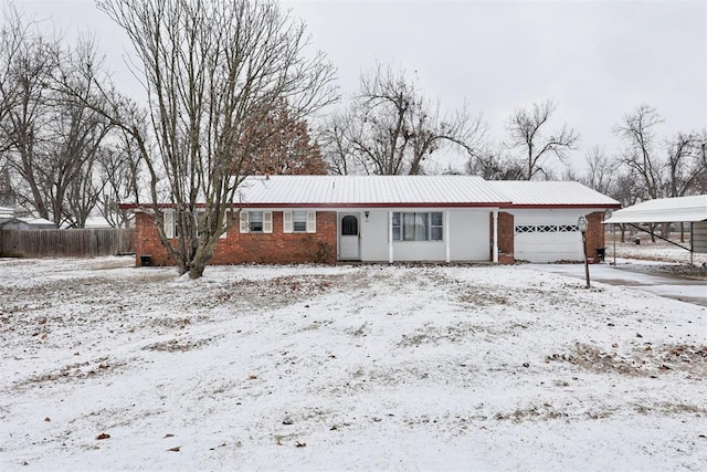 view of front of property featuring a garage and a carport