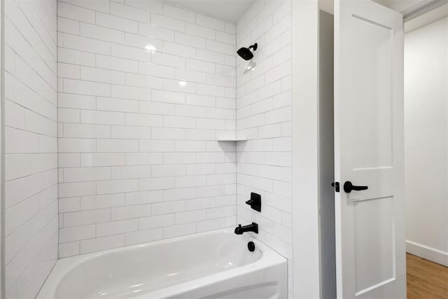 bathroom with tiled shower / bath combo and hardwood / wood-style floors