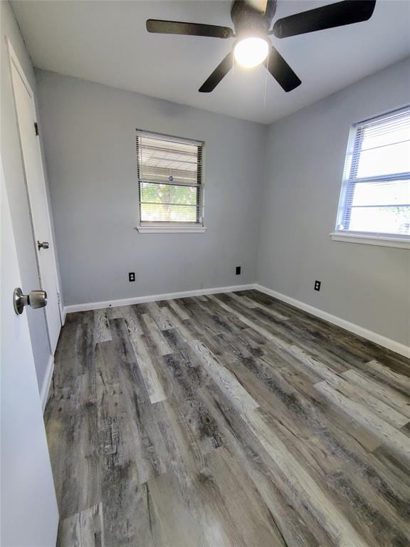 spare room with wood finished floors, baseboards, and ceiling fan