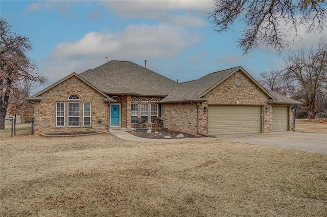 view of front of property with a garage and a front lawn