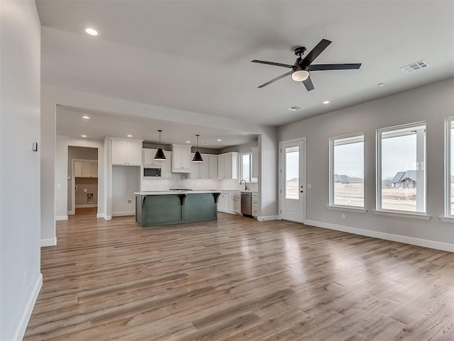 6209 Rivergate Dr, Shawnee, OK 74804 - unfurnished living room featuring ceiling fan, sink, and light hardwood / wood-style floors