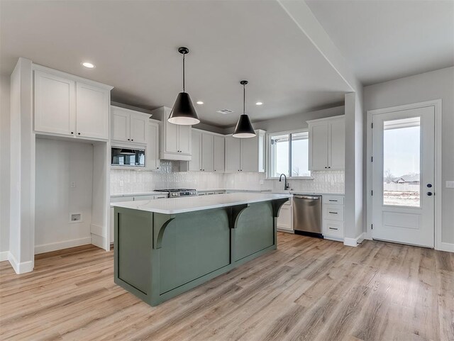 6209 Rivergate Dr, Shawnee, OK 74804 - kitchen with sink, dishwasher, white cabinetry, a center island, and decorative light fixtures