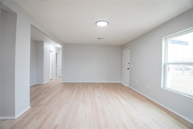 empty room featuring light wood-type flooring and a wealth of natural light