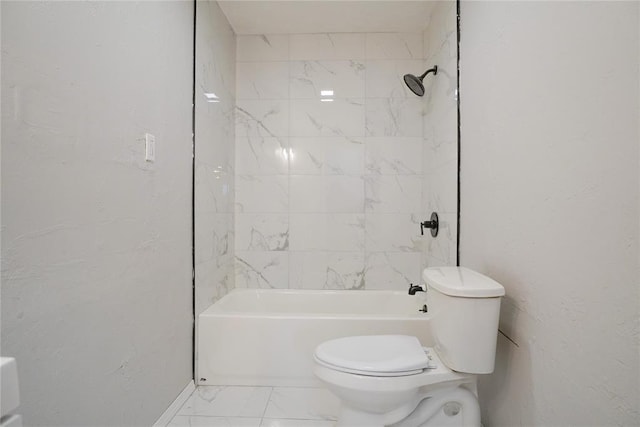 bathroom featuring tiled shower / bath and toilet