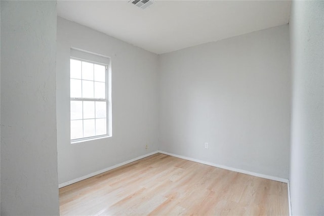 unfurnished room featuring light hardwood / wood-style floors