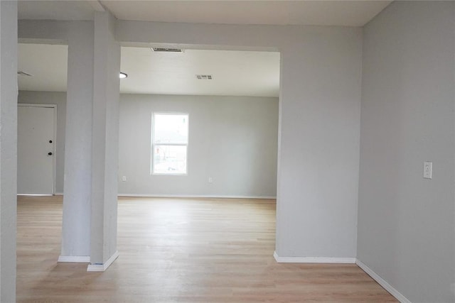 unfurnished room with light hardwood / wood-style floors