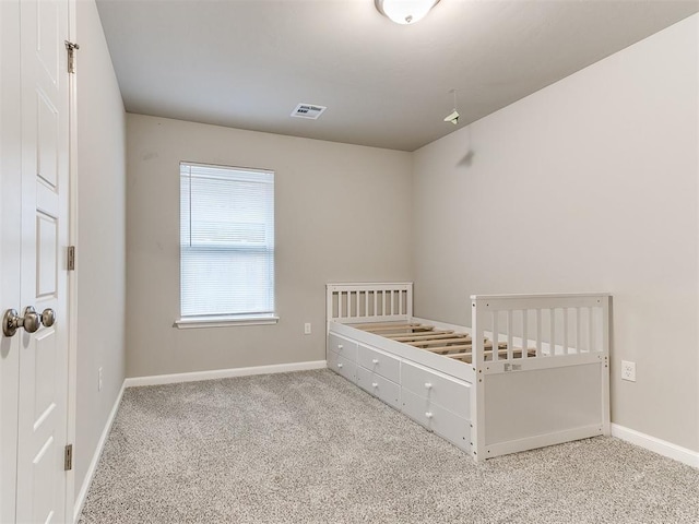 unfurnished bedroom with light colored carpet