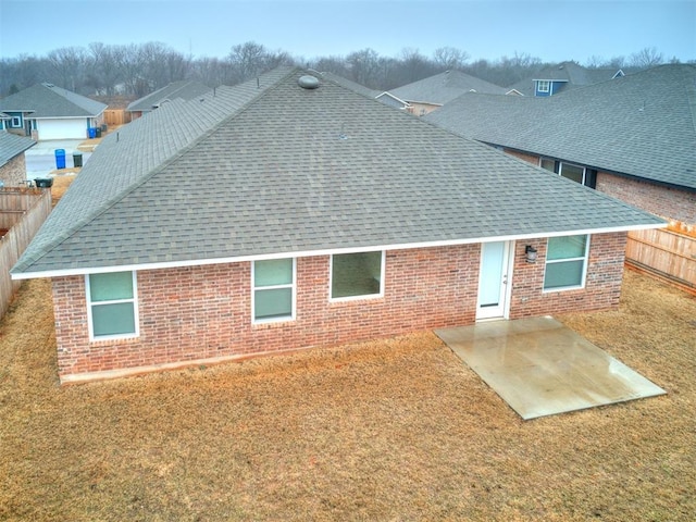 rear view of property with a patio and a lawn