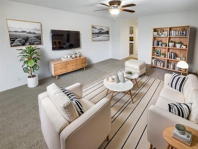 carpeted living room with ceiling fan