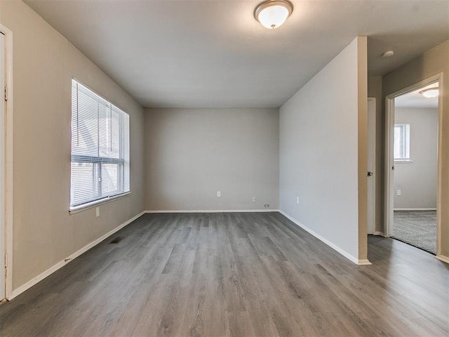 unfurnished room with wood-type flooring