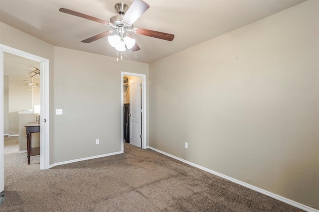 unfurnished bedroom with ceiling fan, carpet floors, a walk in closet, and a closet