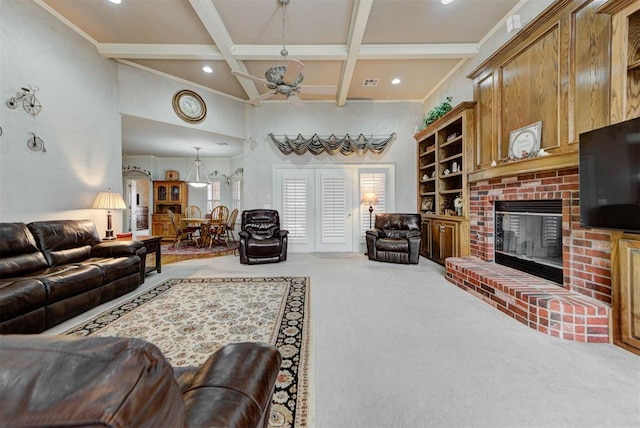 carpeted living room with coffered ceiling, beam ceiling, a towering ceiling, ceiling fan, and a fireplace