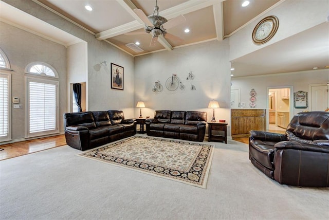 carpeted living room with coffered ceiling, a towering ceiling, ornamental molding, and beamed ceiling