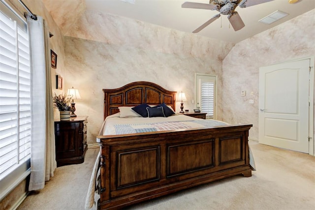 bedroom with multiple windows, light colored carpet, and ceiling fan