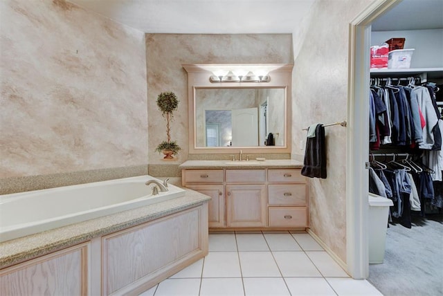 bathroom with vanity, tile patterned floors, and a tub to relax in