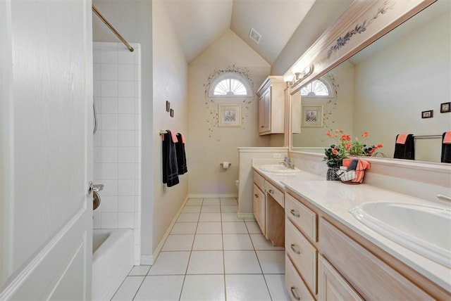 full bathroom with tile patterned floors, lofted ceiling, toilet, tiled shower / bath, and vanity