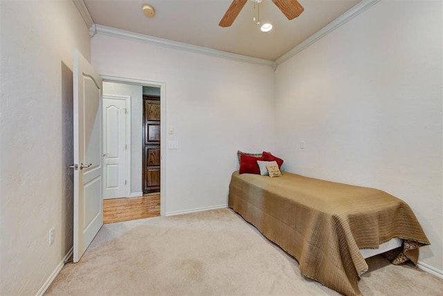 bedroom with crown molding, carpet floors, and ceiling fan