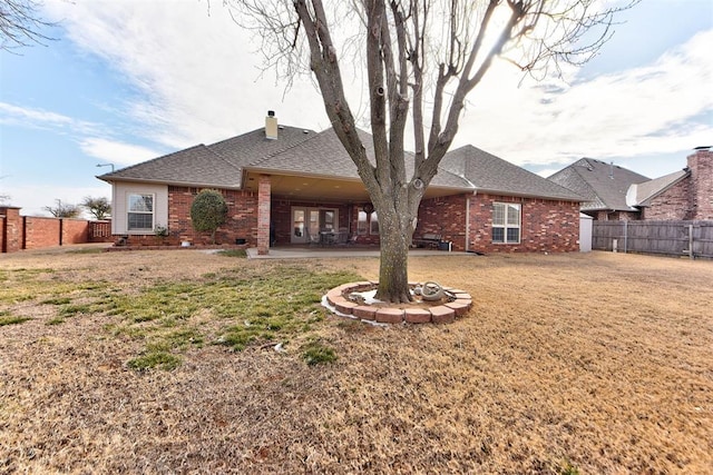 back of property featuring a yard and a patio