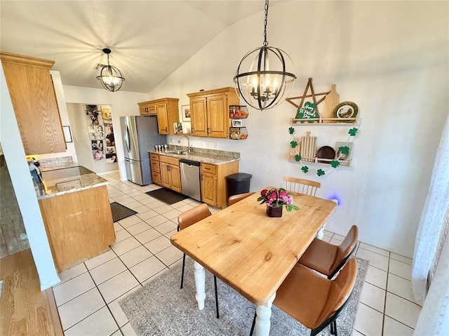 tiled dining room featuring vaulted ceiling, sink, and a chandelier