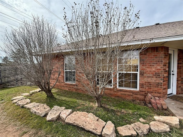 view of side of home with a lawn