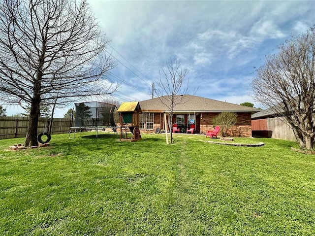 2800 Gettysburg Dr, Altus, OK 73521 - back of house featuring fence, a trampoline, and a yard
