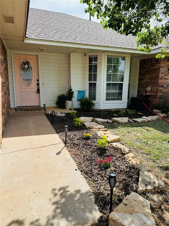 2800 Gettysburg Dr, Altus, OK 73521 - property entrance featuring brick siding and a shingled roof