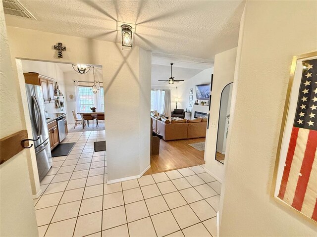 2800 Gettysburg Dr, Altus, OK 73521 - kitchen with a textured ceiling, visible vents, light tile patterned floors, and stainless steel appliances